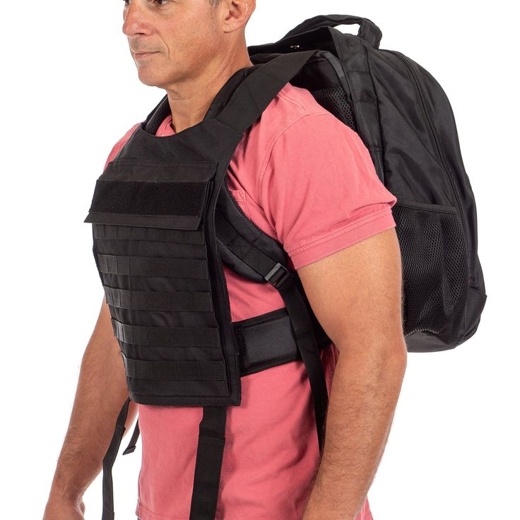 a man with a backpack on his back is looking at the camera while wearing a pink shirt