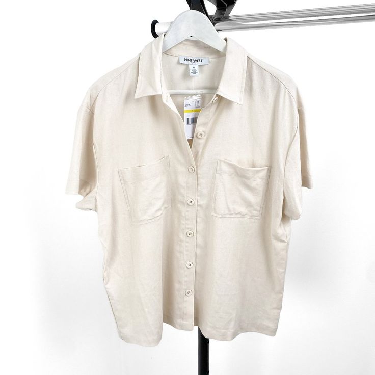 Add A Touch Of Sophistication To Your Wardrobe With This Elegant Nine West Women's Beige Solid Collar Short Sleeve Button Down Blouse, Available In Sizes Medium And Large. Crafted From High-Quality Materials, This Blouse Features A Classic Beige Hue And A Stylish Collar Design, Perfect For Both Casual And Formal Occasions. Whether You're Dressing For The Office Or A Weekend Brunch, This Versatile Blouse Offers Comfort And Style In One Chic Piece. Key Features: Brand: Nine West Gender: Women's Type: Blouse Style: Button Down Color: Beige Sleeve Length: Short Sleeve Closure: Button Down Available Sizes: Medium, Large Elevate Your Look With This Timeless Blouse That Pairs Effortlessly With Je Spring Beige Button-up Blouse, Beige Buttoned Blouse For Summer, Beige Summer Shirt With Button Closure, Beige Button Closure Shirt For Summer, Summer Beige Blouse With Buttons, Neutral Everyday Top With Button Closure, Neutral Everyday Tops With Button Closure, Neutral Tops With Button Closure For Everyday, Elegant Beige Summer Shirt