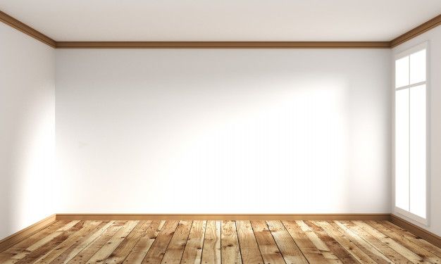 an empty room with wooden floors and white walls