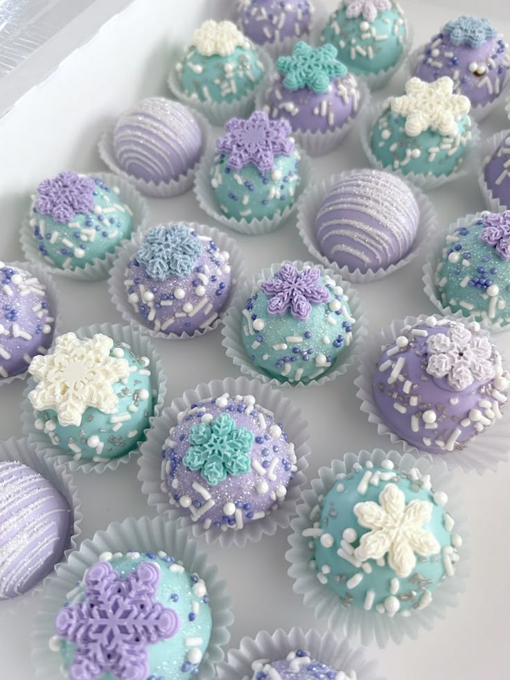 purple and blue decorated cupcakes on a white plate