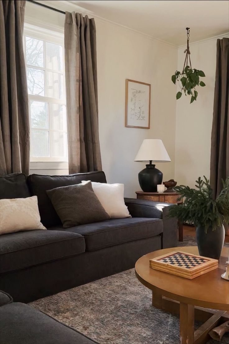 a living room with two couches and a coffee table in front of the window