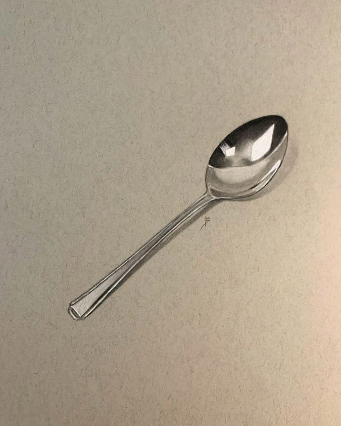 a silver spoon sitting on top of a counter