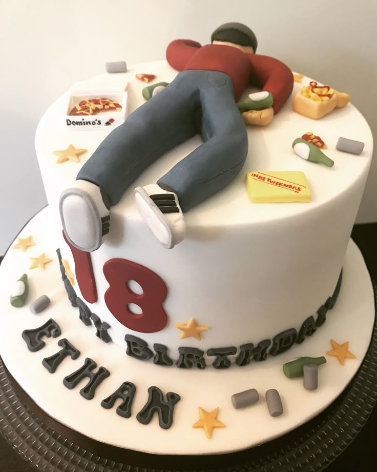 a birthday cake with a man sleeping on top