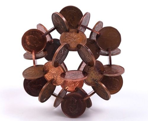 a bunch of coins that are sitting in the middle of a flower shape brooch