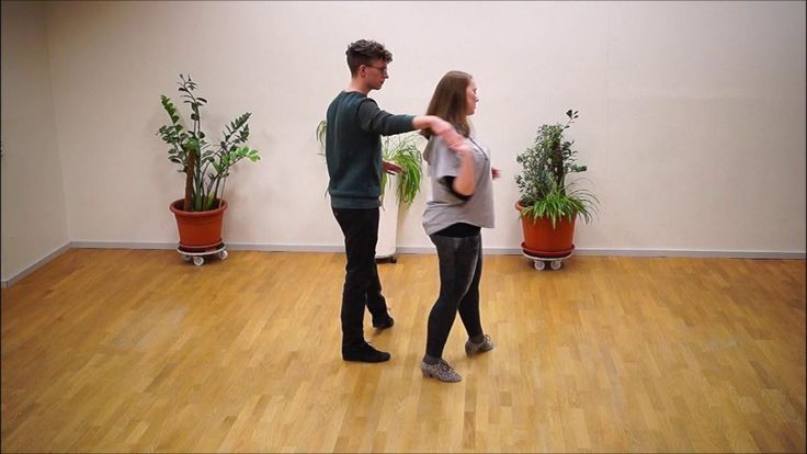 a man and woman dancing in an empty room