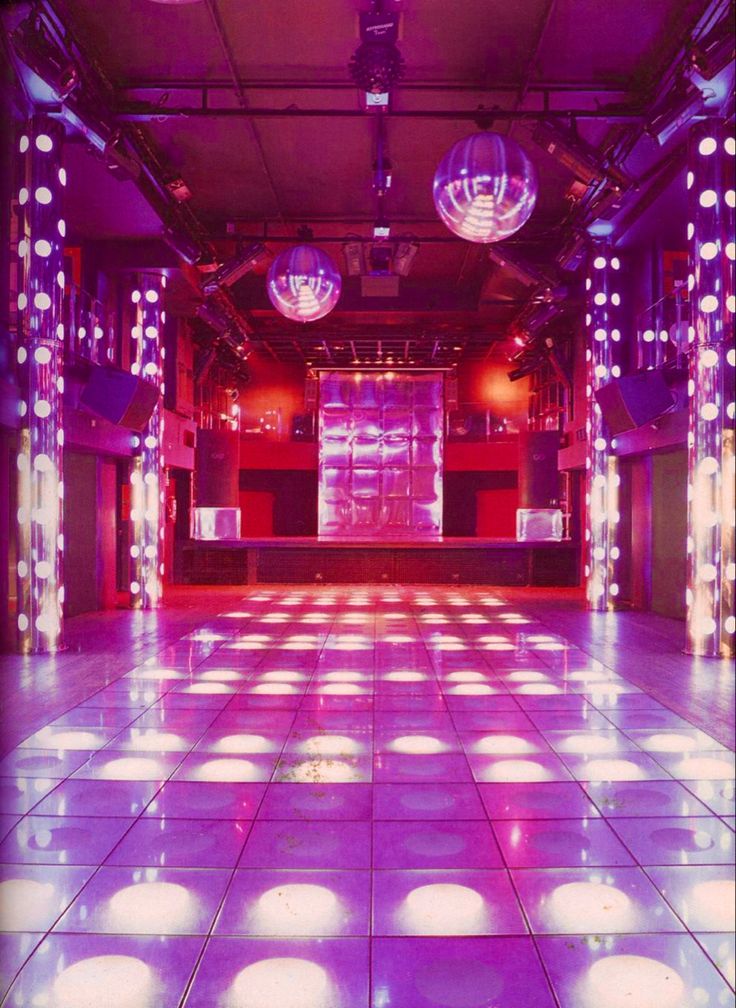 an empty dance floor with disco balls and lights