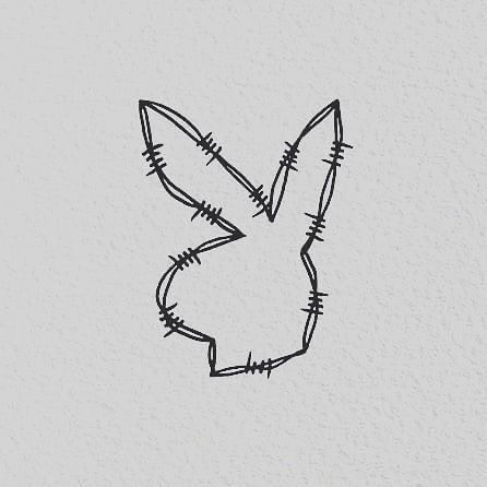 a black and white drawing of a rabbit's head with barbed wire on it