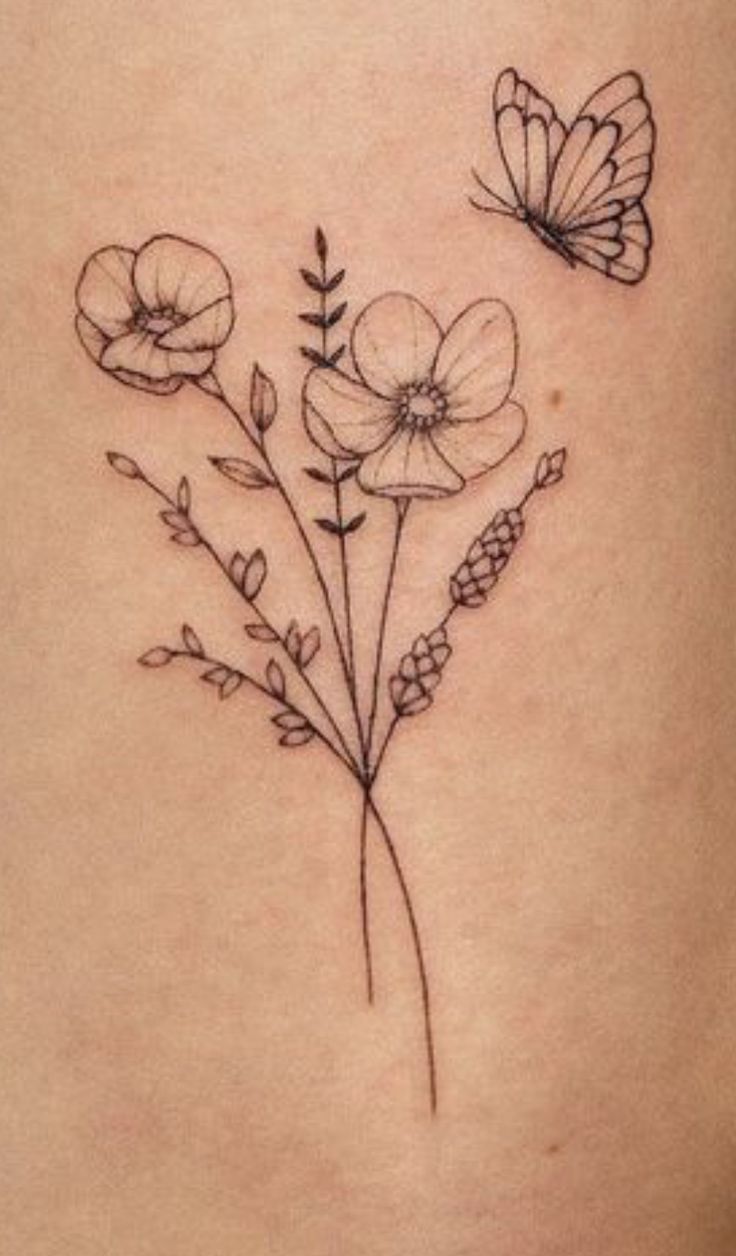 a woman's stomach with flowers and butterflies tattoo on her side ribcage