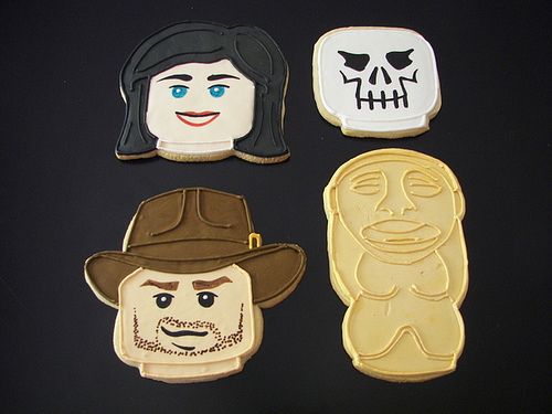 four cookies decorated to look like people with faces on them