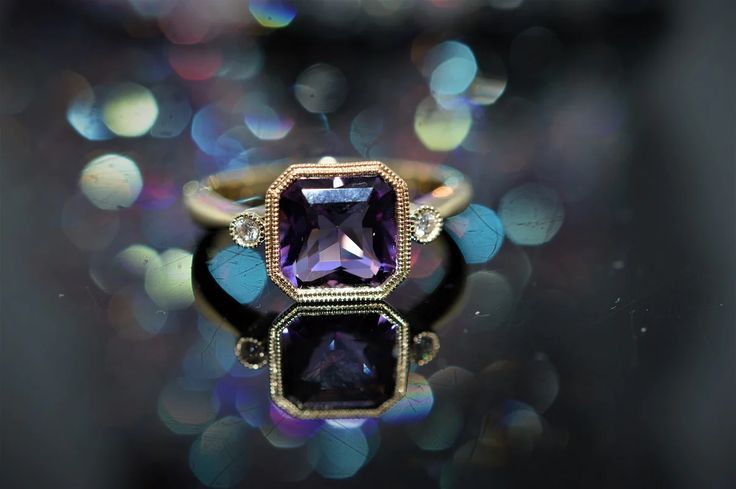 A ladies 14 karat yellow gold amethyst and diamond ring set with a square shape amethyst weighing 1.89 carats and 2 round brilliant cut diamonds having a total weight of .04 carats. Wedding Purple Amethyst Ring With Bezel Setting, Purple Amethyst Ring With Bezel Setting For Wedding, Formal Purple Sapphire Ring With Gemstone Accents, Formal Amethyst Rings With Bezel Setting, Heirloom Amethyst Ring With Center Stone, Heirloom Purple Amethyst Ring With Center Stone, Formal Amethyst Ring With Bezel Setting, Purple Amethyst Ring With Bezel Setting For Anniversary, Formal Purple Amethyst Ring With Bezel Setting