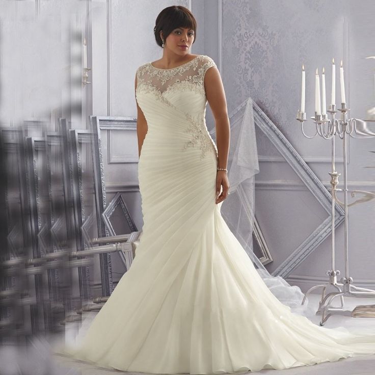 a woman in a wedding dress posing for the camera with her hand on her hip