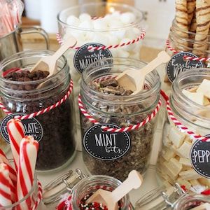 several jars filled with different types of food and candy canes on top of a table