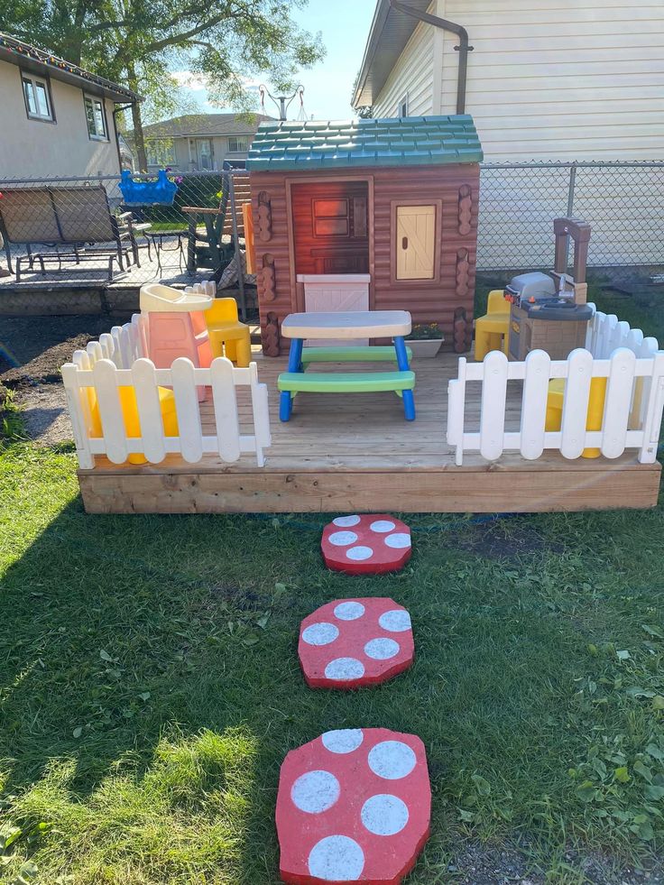 an outdoor play area made out of pallet wood and painted with polka dot paint