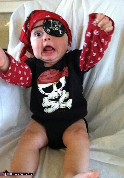 a baby wearing pirate eye patch on top of it's head