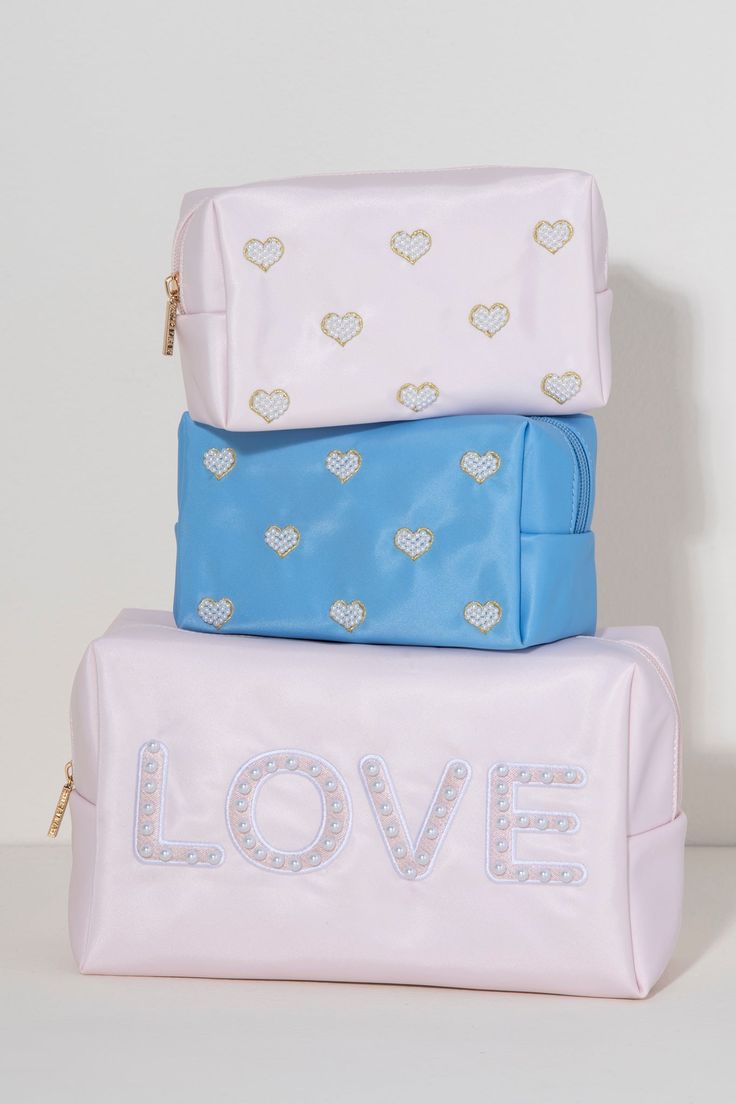 Carry all your odds and ends in style with Shiraleah's "Love" Zip Pouch. Made of durable polyester in light pink, this rectangular case is the perfect size to sit in a drawer or be carried on the go. The chic embroidered faux pearls spell out the word "Love" which make it the perfect pouch to take with you wherever you go. Pair with other items from Shiraleah to complete your look! Features A Top Zip Closure And Embroidered Faux Pearl Design Shiraleah Is A Trend-Driven Lifestyle Brand Focused On The Little Gifts That Make Life Special! Made From Polyester And Faux Pearls Measures L 9.5" X W 4" X H 6" Made In China Pink Rectangular Cosmetic Bag For Storage, Pink Rectangular Cosmetic Bag, Pink Rectangular Pouch For Storage, Pink Rectangular Pencil Case With Removable Pouch, Rectangular Pink Pouch For Personal Use, Trendy Pink Cosmetic Bag For Storage, Pink Rectangular Pouch, Pink Rectangular Pouch For Personal Use, Pink Rectangular Pouch As Gift