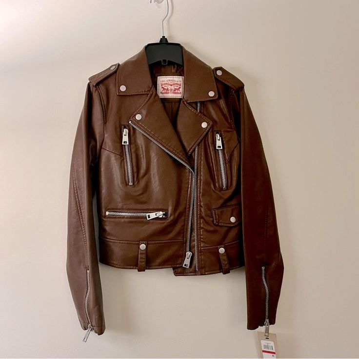 Condition: New, Never Worn Rich Brown Faux Leather Jacket. Classic Fit. Zip Closure. Runs Large. Levi's Brown Outerwear For Spring, Brown Levi's Outerwear For Spring, Levi's Leather Jacket For Fall, Levi's Biker Leather Jacket For Winter, Levi's Biker Outerwear With Zipper Closure, Levi's Biker Leather Jacket, Levi's Biker Jacket For Fall, Levi's Fitted Biker Outerwear, Levi's Biker Leather Jacket For Spring