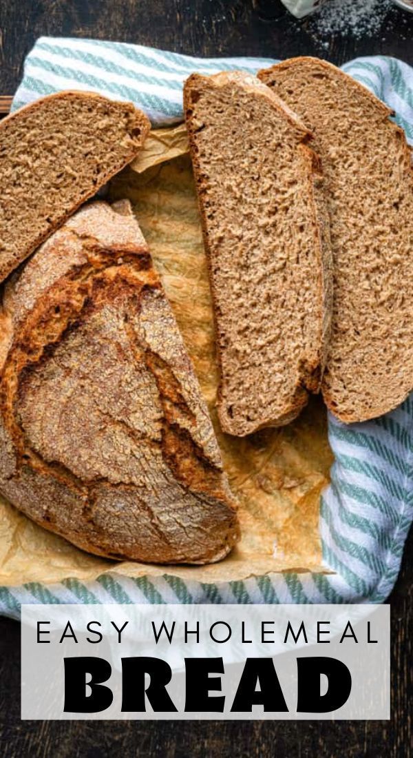 an easy wholemeal bread is cut in half and sitting on a blue towel