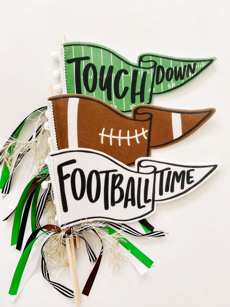 two football themed toothpicks with the words touch down and football time on them