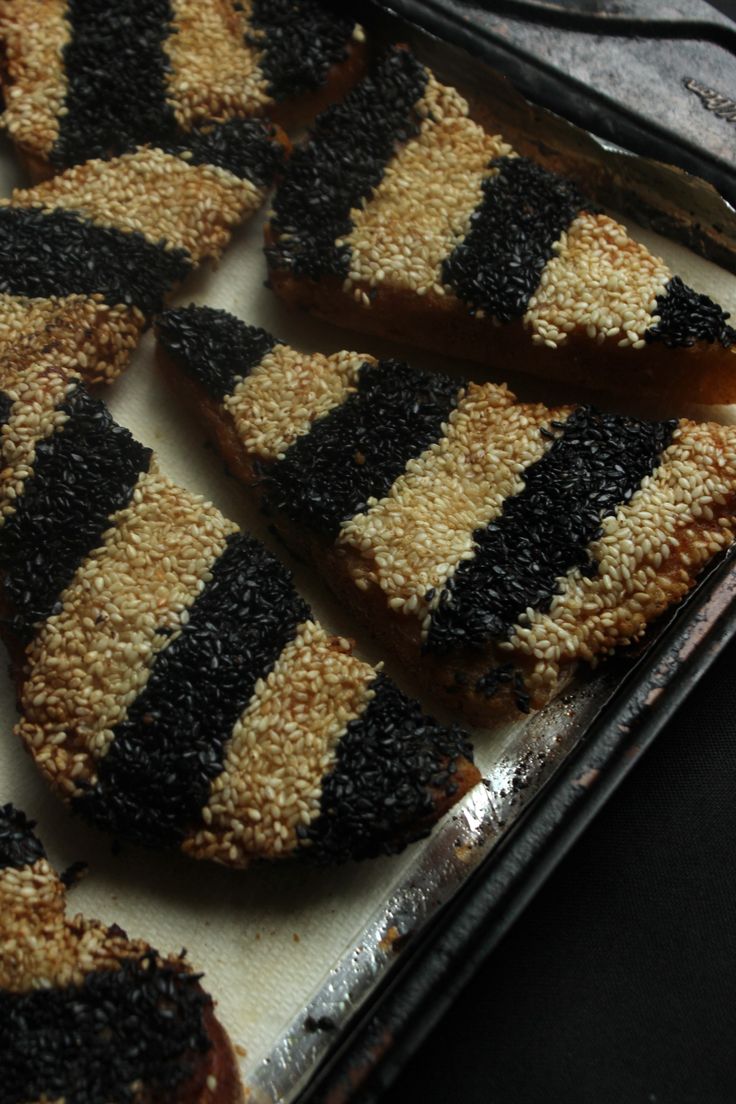 some black and white cookies are on a tray