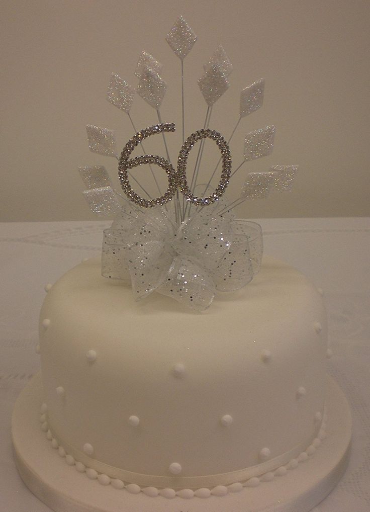 a white cake with silver decorations on top