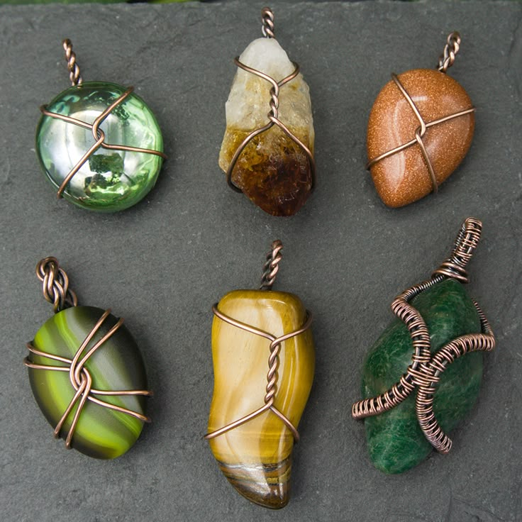 six different colored stones with wire wrapped around them