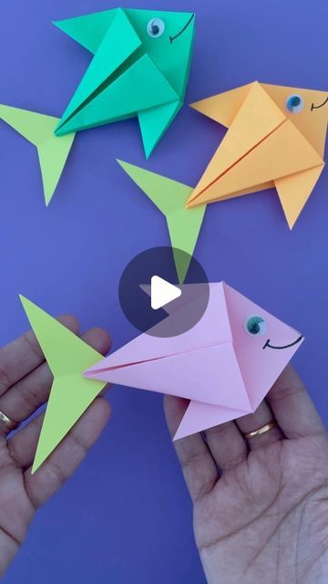 origami fish being held by someone's hand