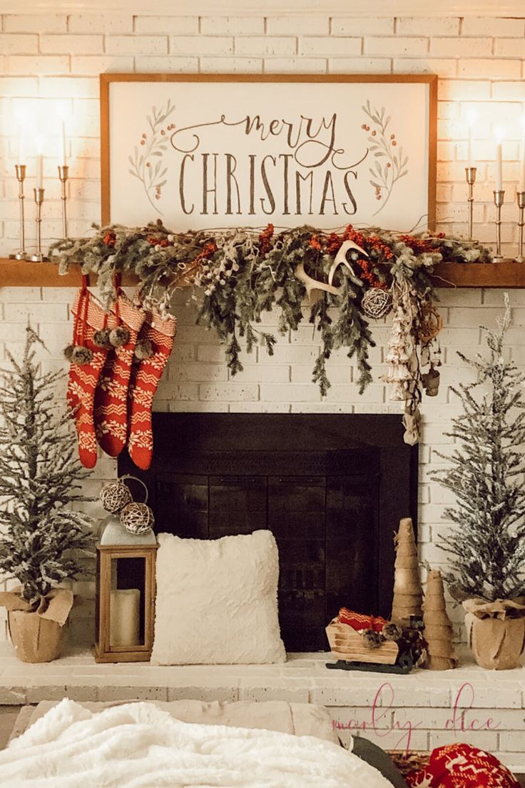 a fireplace decorated for christmas with stockings hanging from the mantel