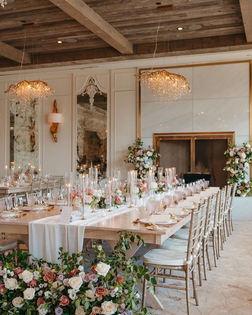 a long table is set with flowers and candles