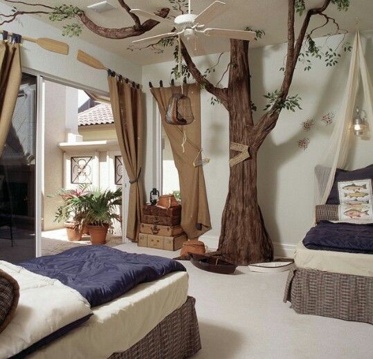 a bedroom decorated with trees and hammocks hanging from the ceiling