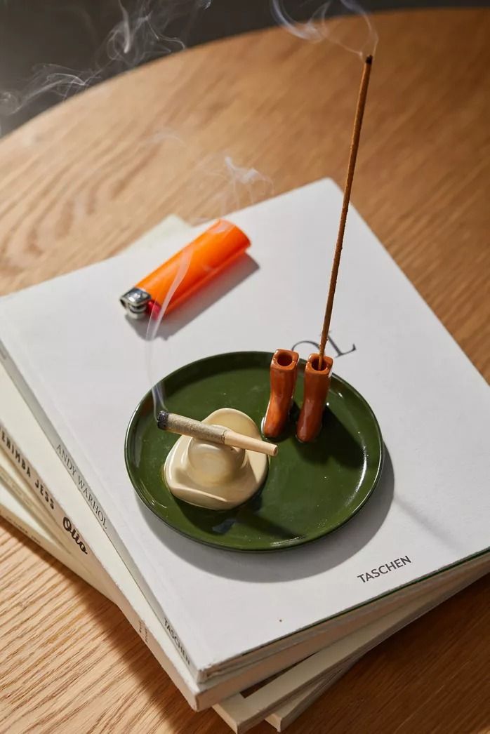 a green plate topped with food on top of a wooden table next to a book