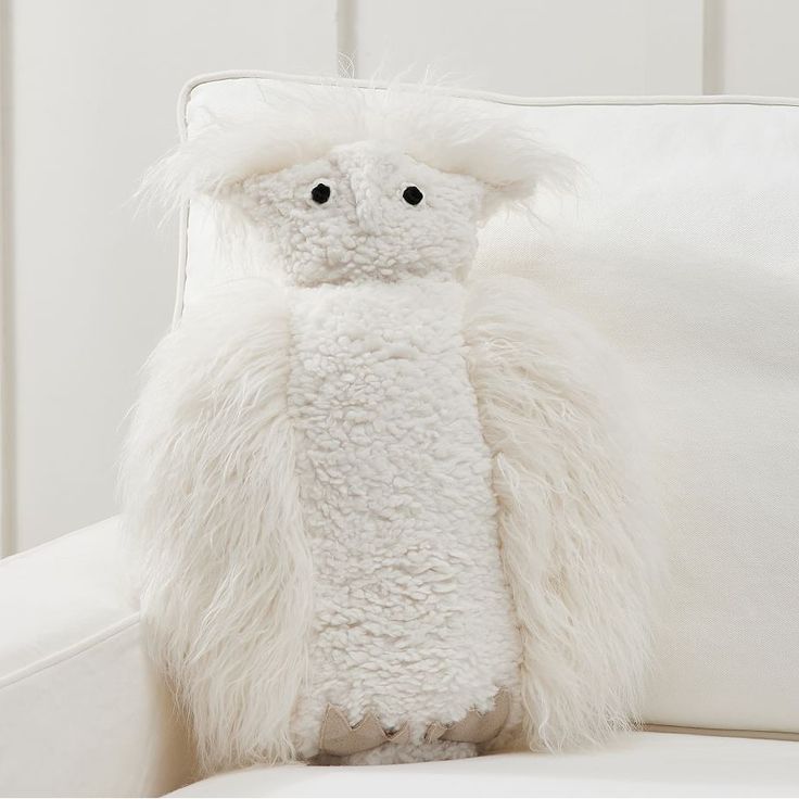 a stuffed animal sitting on top of a white couch