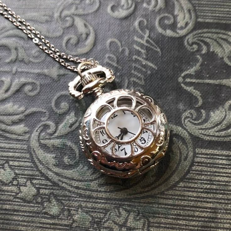 Small 25mm pocket watch necklace with a high quality quartz movement inside. On 30 inches of chain. I can make this chain any length for no extra charge. Just leave me a note at checkout! You can adjust the time by pulling up the knob and turning.Pressing the knob opens the watch. Available in either gunmetal or silver. Each watch comes in a gift box with printed instructions and an extra battery. Clock Necklace, Baking Desserts, Pocket Watch Necklace, Magical Jewelry, Fantasy Story, Pocket Watches, Fantasy Jewelry, Jewelry Inspo, Watch Necklace