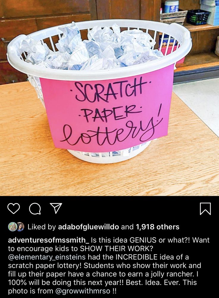 a pink bucket filled with lots of ice sitting on top of a wooden table next to a book shelf