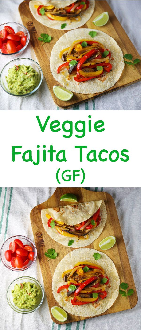 three tacos on a cutting board with guacamole and tomatoes