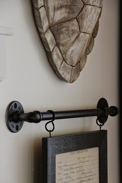 a wooden heart hanging on the wall next to a framed photograph