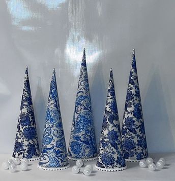 five blue and white christmas trees are lined up