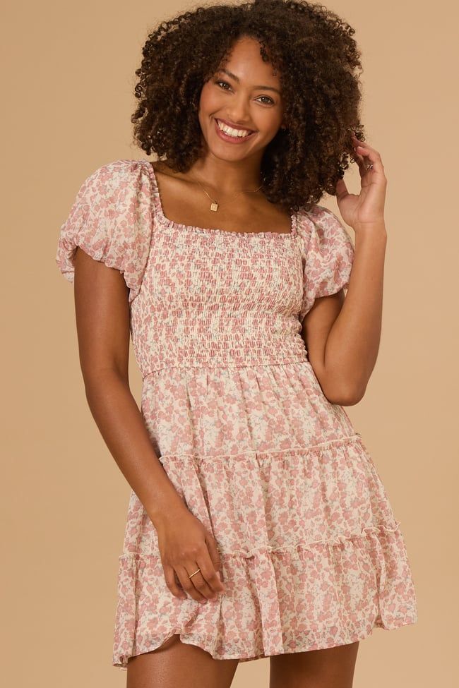 Featuring a delicate floral print and flattering puff sleeves, this dress is perfect for any occasion. The smocked bodice offers a comfortable, flattering fit, while the mini length keeps it fresh and modern. Square Neck Ditsy Floral Dress For Day Out, Square Neck Smocked Dress With Floral Print, Square Neck Floral Print Smocked Dress, Pink Smocked Dress With Floral Print And Square Neck, Fitted Floral Mini Dress With Smocked Back, Flowy Puff Sleeve Floral Dress With Square Neck, Flowy Square Neck Puff Sleeve Dress With Floral Print, Feminine Smocked Dress With Ditsy Floral Print For Spring, Spring Feminine Smocked Dress With Ditsy Floral Print