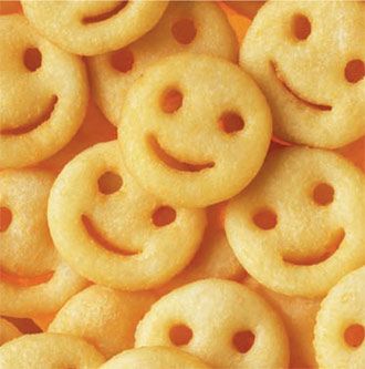 a pile of smiley face cookies sitting on top of each other