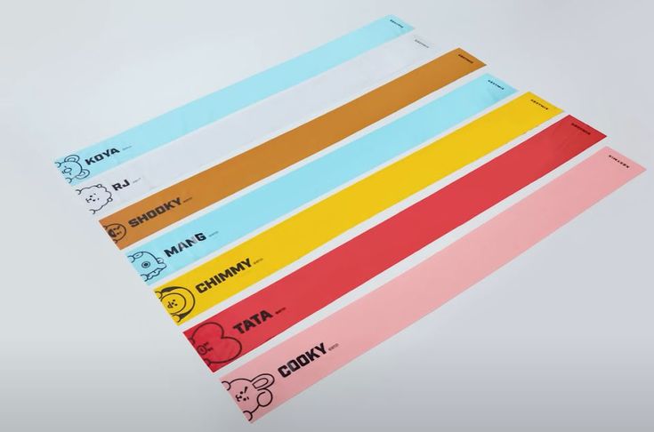 four different colored stickers on top of each other in front of a white background