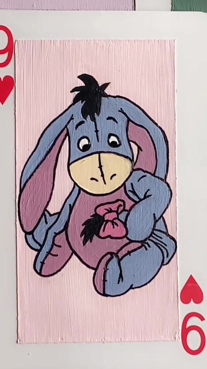 a card with a drawing of a bunny holding a heart on it's chest