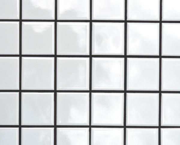 a white and black tiled wall with no one in it