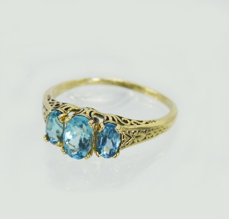 "14k yellow gold antique victorian ring , with 3 beautiful and real blue topaz gem stones . Hand made by myself Weight : about 1.9 gram Central stone : blue topaz 4/6 m\"m side stones : 2 blue topaz 3/5 m\"m" Blue Topaz Ring With Rose Cut Diamonds, Vintage Yellow Gold Rings With Blue Topaz, Victorian 14k Gold Topaz Ring For Anniversary, Vintage Yellow Gold Blue Topaz Rings, Blue Topaz Ring With Rose Cut Diamonds For Promise, Three-stone Topaz Promise Ring, Three Stone Topaz Promise Ring, Heirloom 14k Gold Hallmarked Topaz Ring, Elegant Three Stone Topaz Wedding Ring