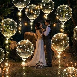 a bride and groom standing in front of bubbles with candles on the ground next to them