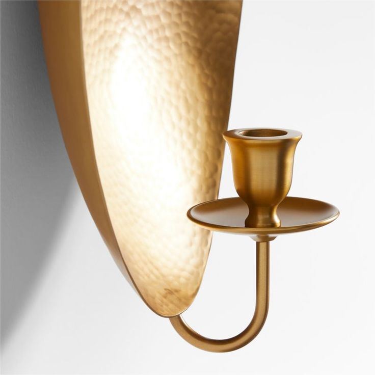 a wall light with a candle holder attached to it