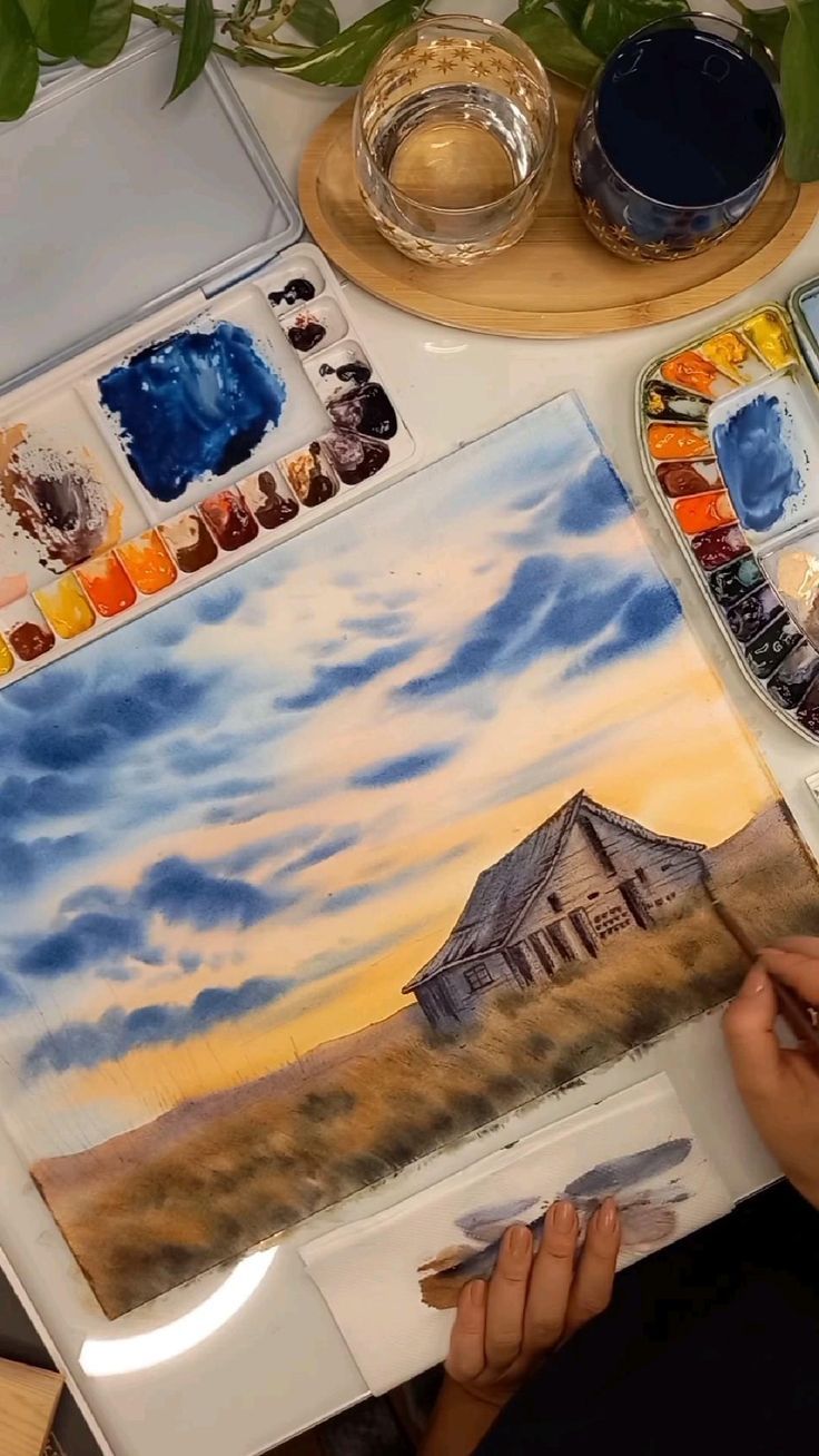 a person is painting an image with watercolors