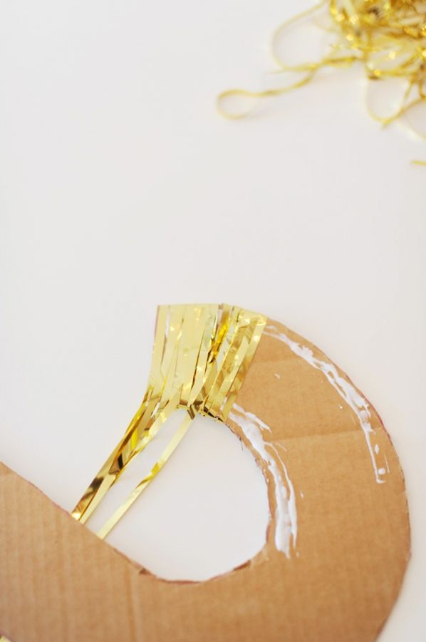 a piece of cardboard sitting on top of a table next to some scissors and string