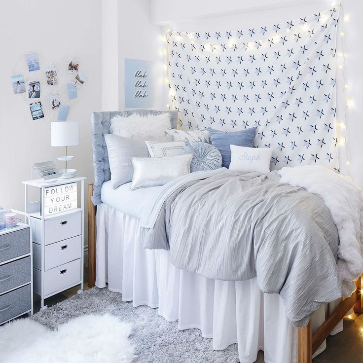 a bed with white sheets and pillows in a room decorated for christmas or new year's eve