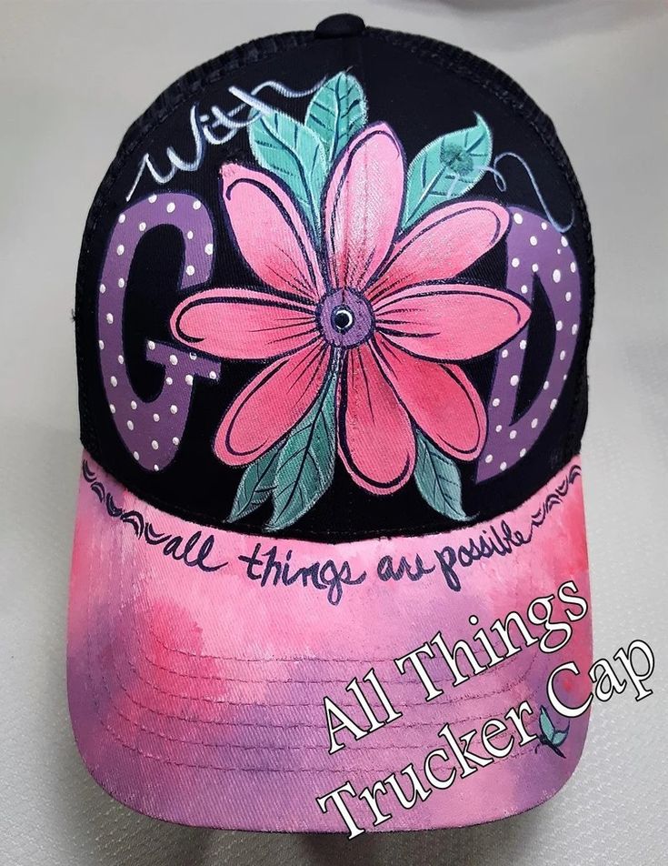 a pink and black trucker cap with a flower on it's front, says go all things are possible