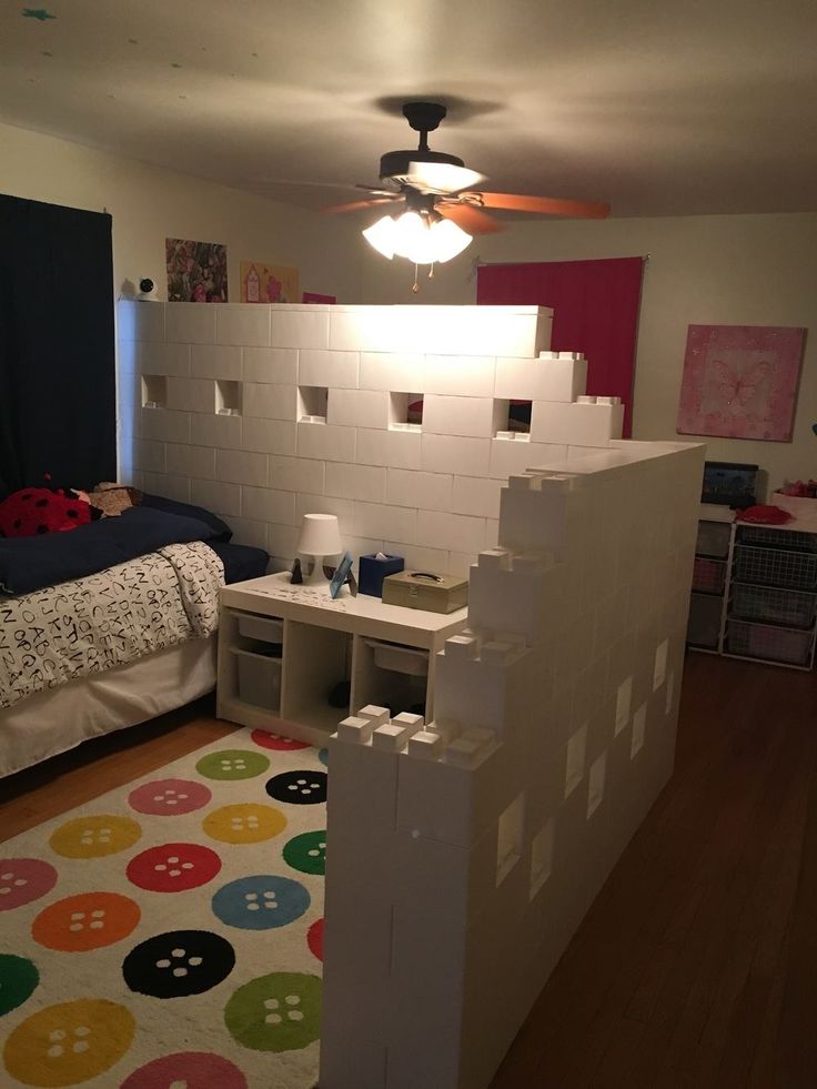 a child's room with a bed, desk and play area in the corner