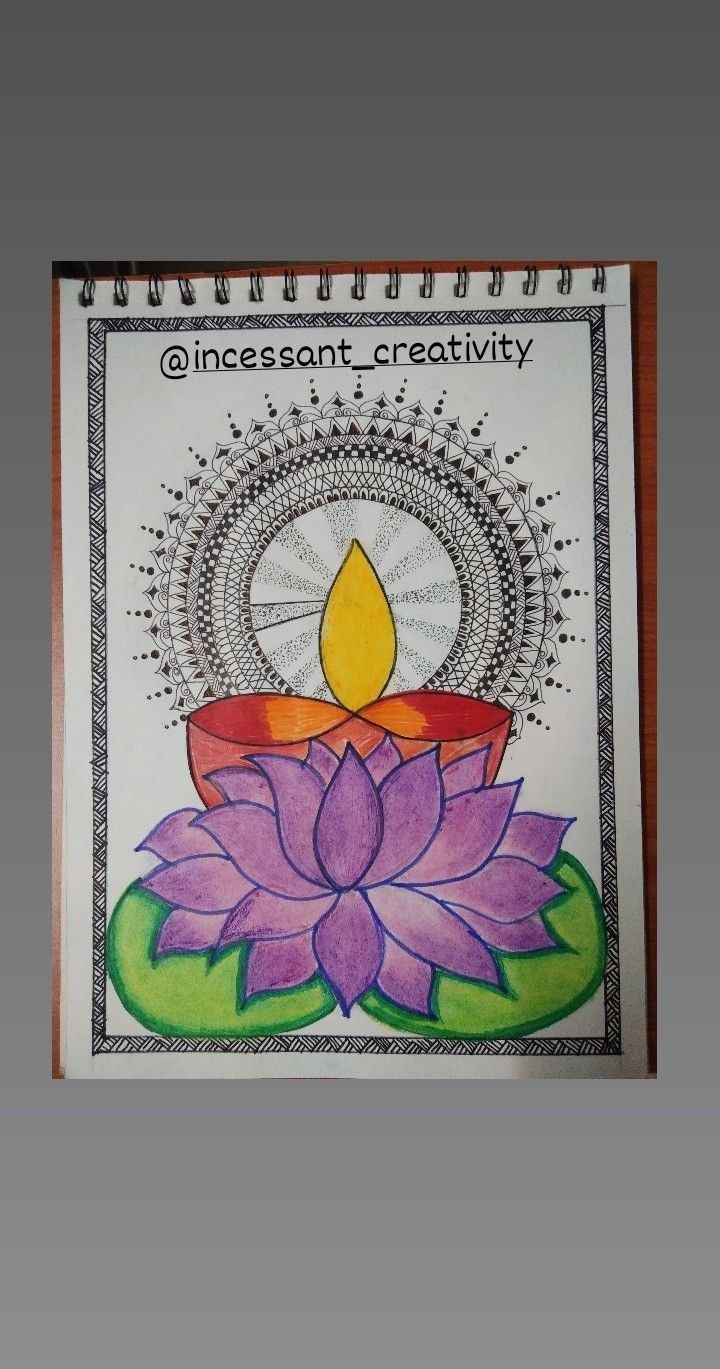 a spiral notebook with a drawing of a candle and lotus flower on the front cover